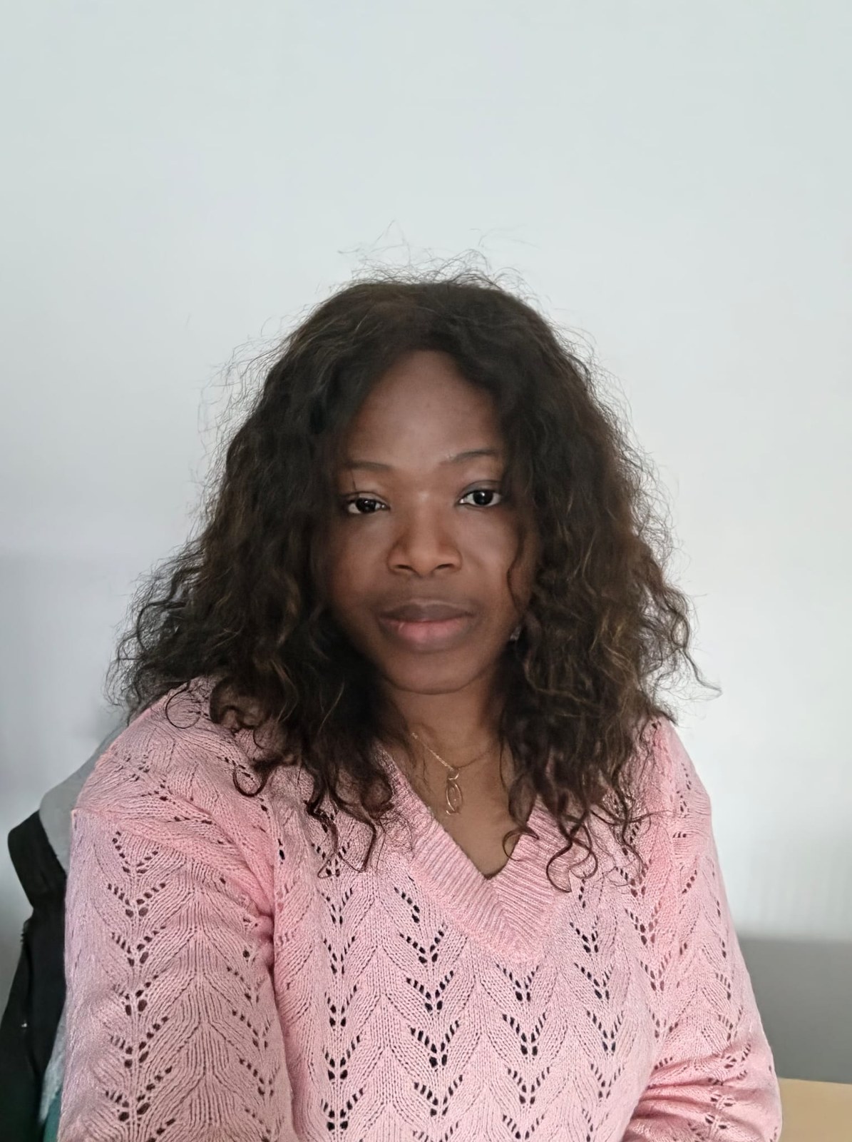 Dr Amarachi Ewulonu in a pink knitted cardigan